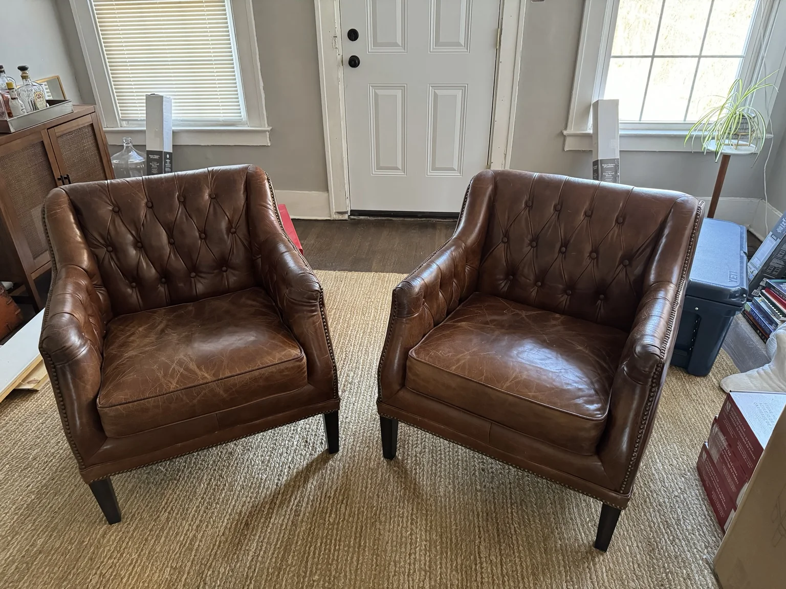 Pair of warm brown leather club chairs selected for the library